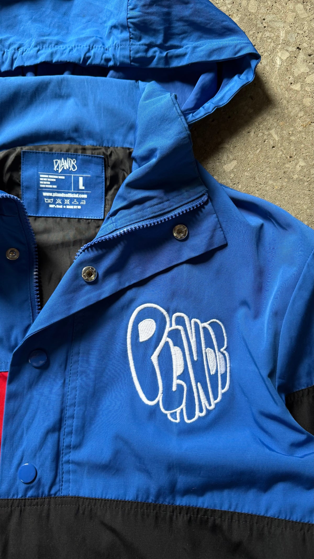 P.LANDS Badge Windbreaker